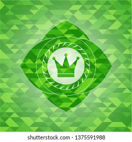 crown icon inside green emblem with triangle mosaic background