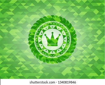 crown icon inside green mosaic emblem
