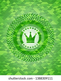 crown icon inside green mosaic emblem