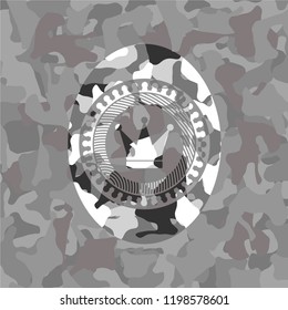 crown icon inside grey camouflaged emblem
