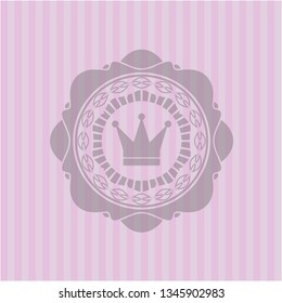 crown icon inside pink emblem