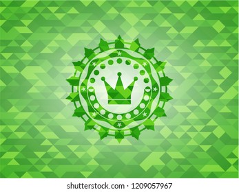 crown icon inside realistic green emblem. Mosaic background