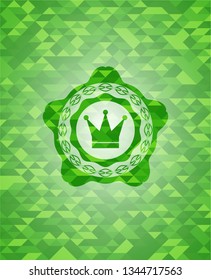 crown icon inside realistic green mosaic emblem