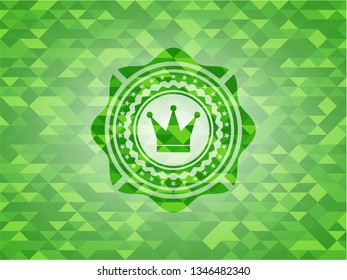 crown icon inside realistic green emblem. Mosaic background