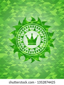 crown icon inside realistic green mosaic emblem