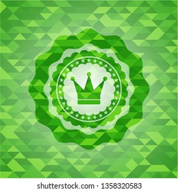 crown icon inside realistic green mosaic emblem
