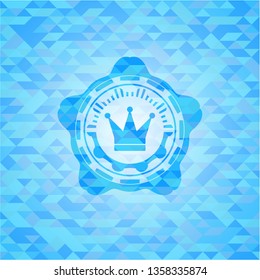 crown icon inside realistic light blue emblem. Mosaic background