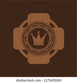 crown icon inside realistic wood emblem