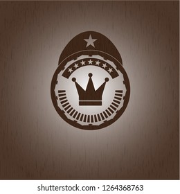 crown icon inside retro style wood emblem