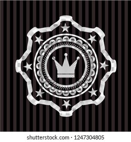 crown icon inside silver emblem or badge