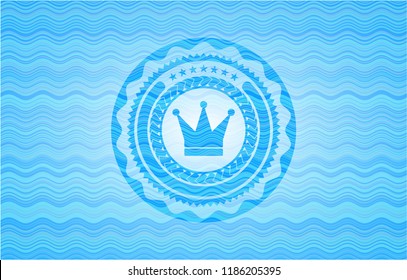 crown icon inside sky blue water wave style emblem.