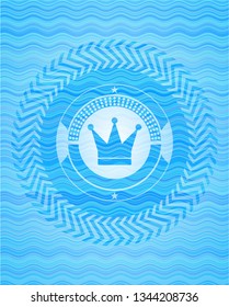 crown icon inside water concept style emblem.