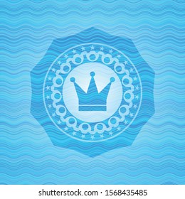 crown icon inside water concept badge.