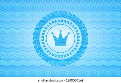 crown icon inside water representation style emblem.