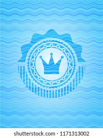 crown icon inside water wave representation badge.