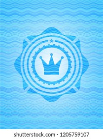 crown icon inside water wave badge.