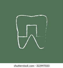 Crowned tooth hand drawn in chalk on a blackboard vector white icon isolated on a green background.