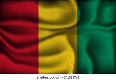 crumpled flag of Guinea on a light background.