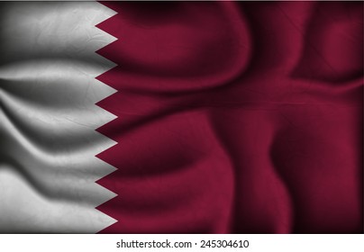 crumpled flag of Qatar on a light background.