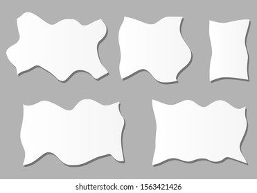 Crumpled pieces of paper on gray background.