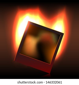 Crumpling blank instant photo shot over burning fire in the darkness