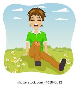Crying boy with wounded leg in park