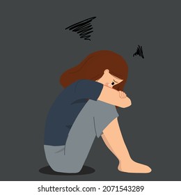 Crying and depressed girl while hugging her knees