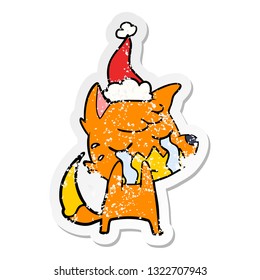 crying fox hand drawn distressed sticker cartoon of a wearing santa hat