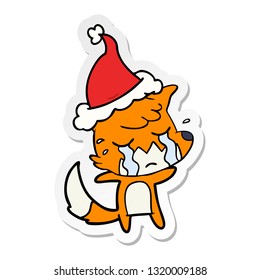 crying fox hand drawn sticker cartoon of a wearing santa hat