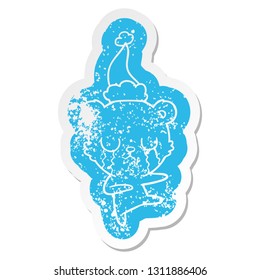 crying polar bear quirky cartoon distressed sticker of a wearing santa hat