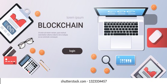 crypto currency block chain concept bitcoin mining workplace desk top angle view tablet laptop computer paper documents report finance graph flat copy space horizontal