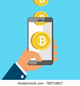 Cryptocurrency concept hand holding smartphone and earning money coins