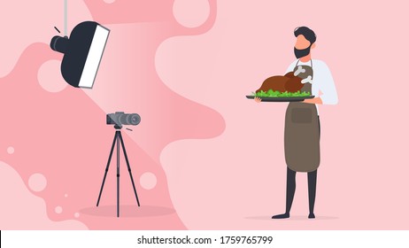 Culinary blogger. A man in a kitchen apron holds a fried chicken on a tray. Camera on a tripod, softbox. Culinary blog or vlog concept. Vector.