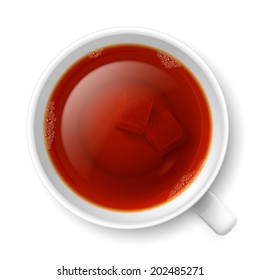 Cup of black tea with lump of cane sugar at the bottom 