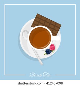 A cup of black tea with a spoon, chocolate and berries. Top view