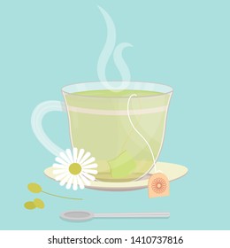 Cup of chamomile tea. Tea sachet with chamomile flower on the saucer. Smoke on the drink. Spoon in front of cup.