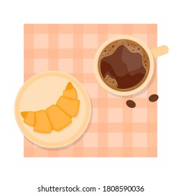 It's a cup of coffee and a croissant on the table.