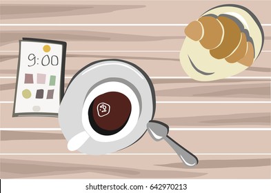 cup of coffee with croissant on the table