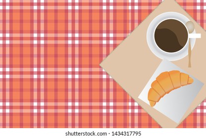 cup of coffee and croissant on tablecloth