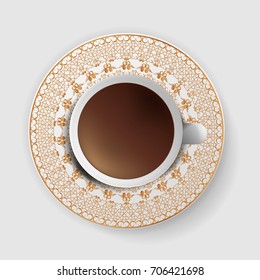 A cup of coffee with a decorative saucer