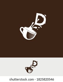 a cup of coffee with the letter D spilled