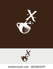 a cup of coffee with the letter X spilled