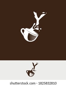 a cup of coffee with the letter Y spilled