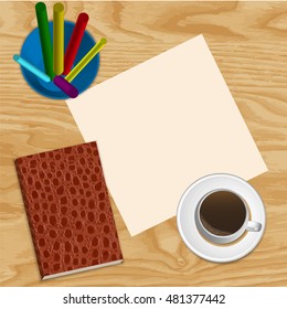 cup of coffee and a notepad with Colour pencils on wooden background