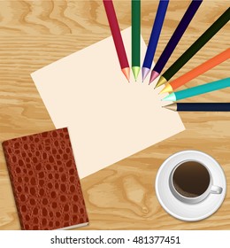 cup of coffee and a notepad with Colour pencils on wooden background
