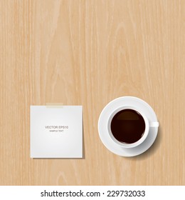 Cup of coffee and white paper stick on wooden background.