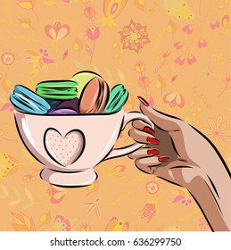 cup with different macaroons on background.