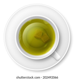 Cup of green tea with brown lump sugar
