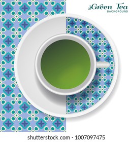 Cup of green tea with colorful ornament on a saucer and geometric seamless pattern. Business coffee break or tea time concept, interior background. Isolated cup and plate decor elements