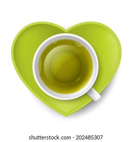 Cup of green tea with saucer in shape of heart